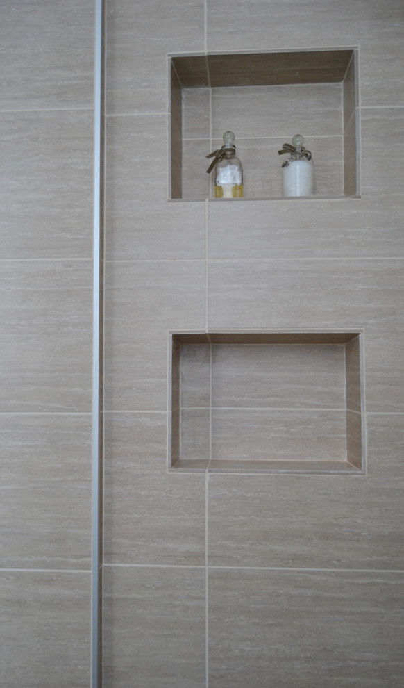 Inspiration for a small contemporary powder room in Milan with beige tile and porcelain tile.