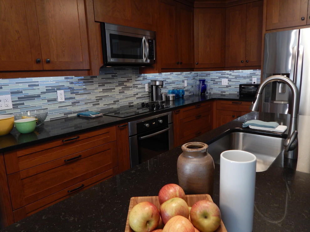 Inspiration for a mid-sized transitional galley cork floor eat-in kitchen remodel with an undermount sink, shaker cabinets, medium tone wood cabinets, quartz countertops, blue backsplash, glass tile backsplash, stainless steel appliances, blue walls and an island