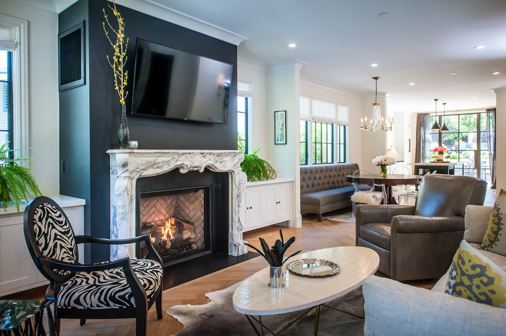 Photo of a mid-sized traditional open concept living room in San Francisco with black walls, light hardwood floors, a standard fireplace and a stone fireplace surround.