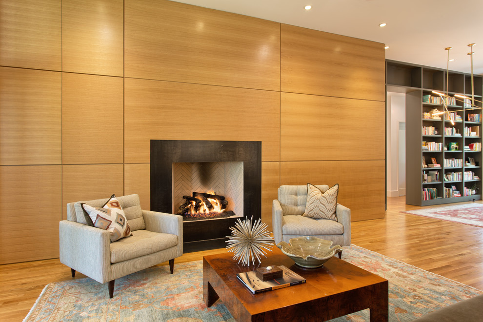 Photo of a contemporary living room in Austin with medium hardwood floors and a standard fireplace.