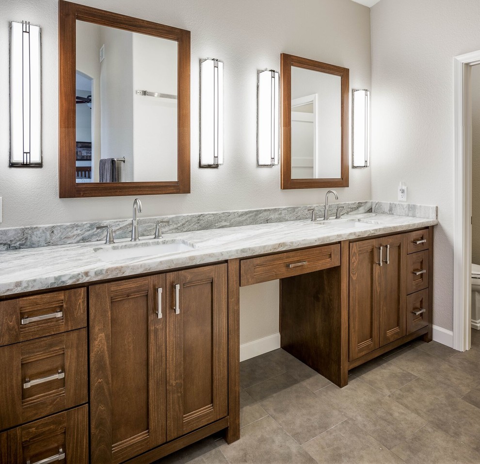 Mid-sized transitional master porcelain tile and gray tile porcelain tile and brown floor drop-in bathtub photo in Phoenix with shaker cabinets, medium tone wood cabinets, a two-piece toilet, white walls, an undermount sink and granite countertops