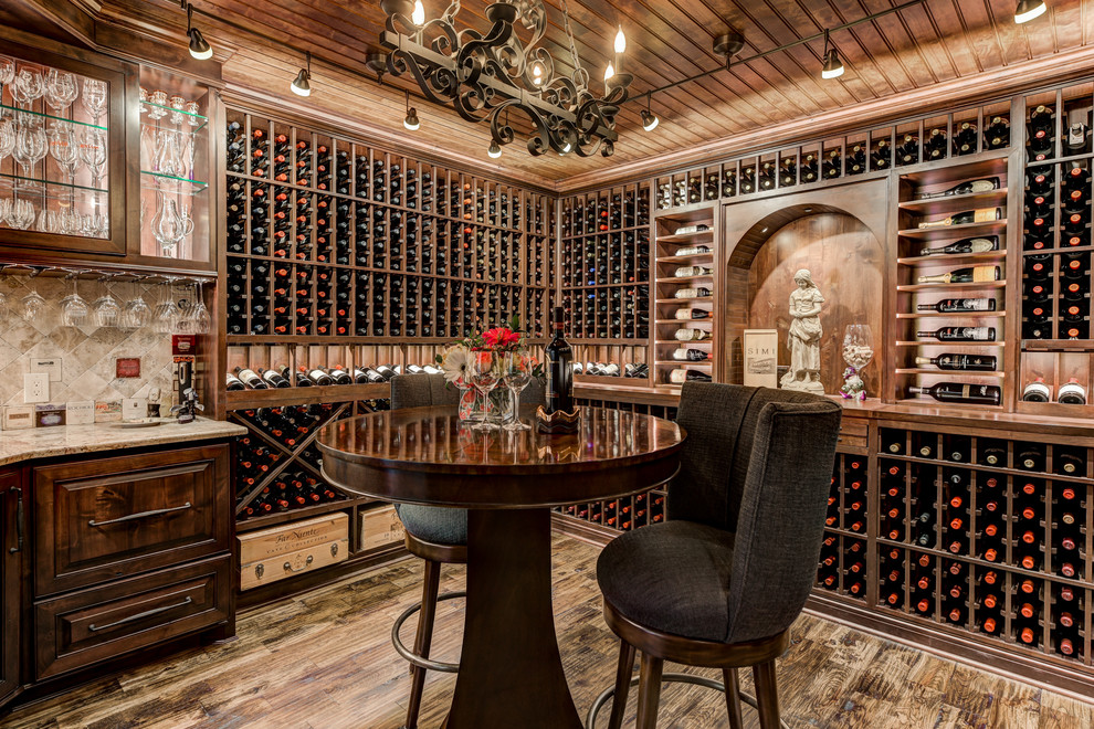 This is an example of a traditional wine cellar in Oklahoma City with storage racks and brown floor.