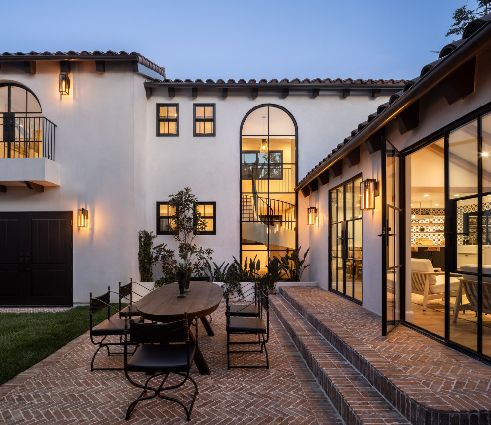 Inspiration for a large mediterranean backyard brick patio remodel in Los Angeles with no cover