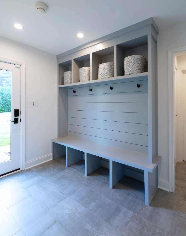 Inspiration for a mid-sized modern mudroom in Philadelphia with white walls, ceramic floors, a single front door, a white front door and grey floor.