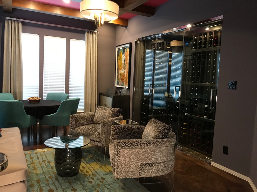 Mid-sized eclectic wine cellar in Houston with medium hardwood floors, storage racks and brown floor.
