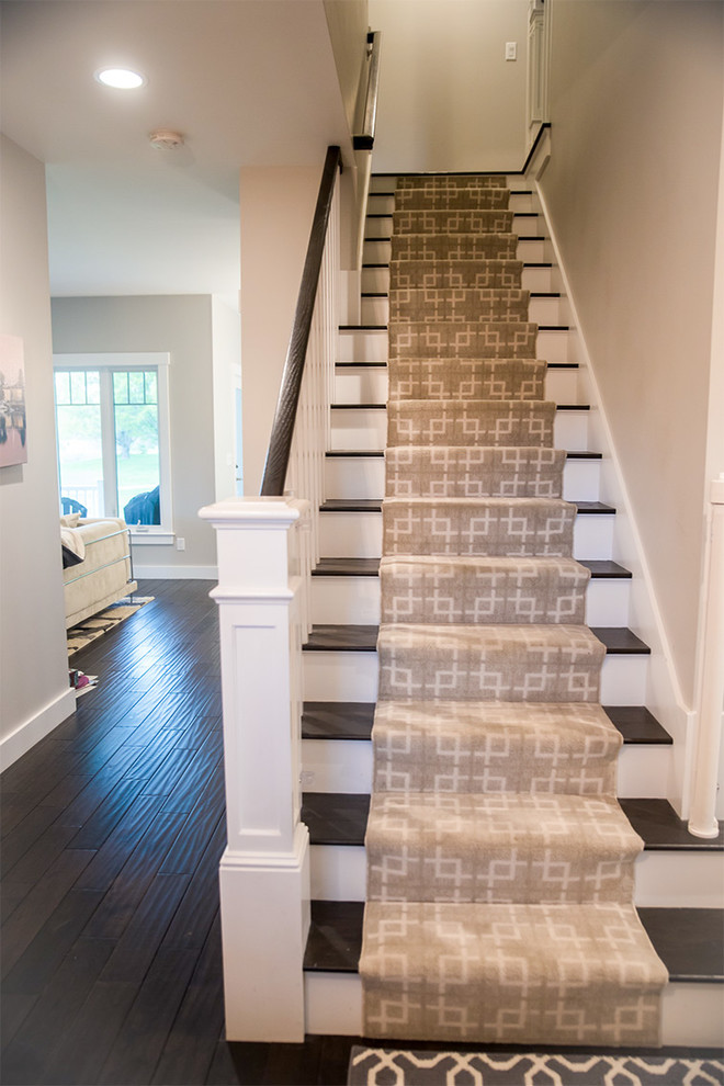 Photo of a traditional wood straight staircase in Burlington with painted wood risers and wood railing.