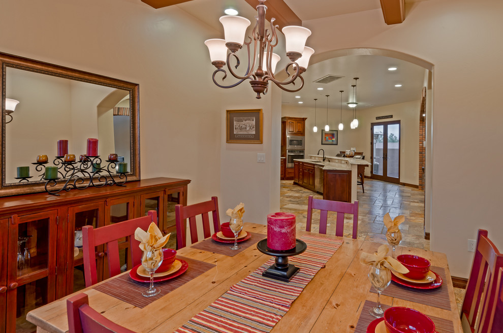 Design ideas for a large mediterranean separate dining room in Albuquerque with beige walls and travertine floors.