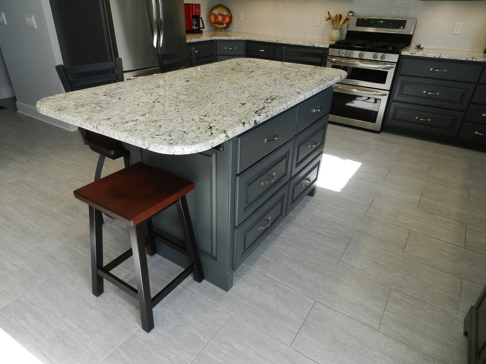 Inspiration for a mid-sized transitional l-shaped porcelain tile and beige floor enclosed kitchen remodel in Cleveland with an undermount sink, raised-panel cabinets, gray cabinets, granite countertops, white backsplash, subway tile backsplash, stainless steel appliances and an island
