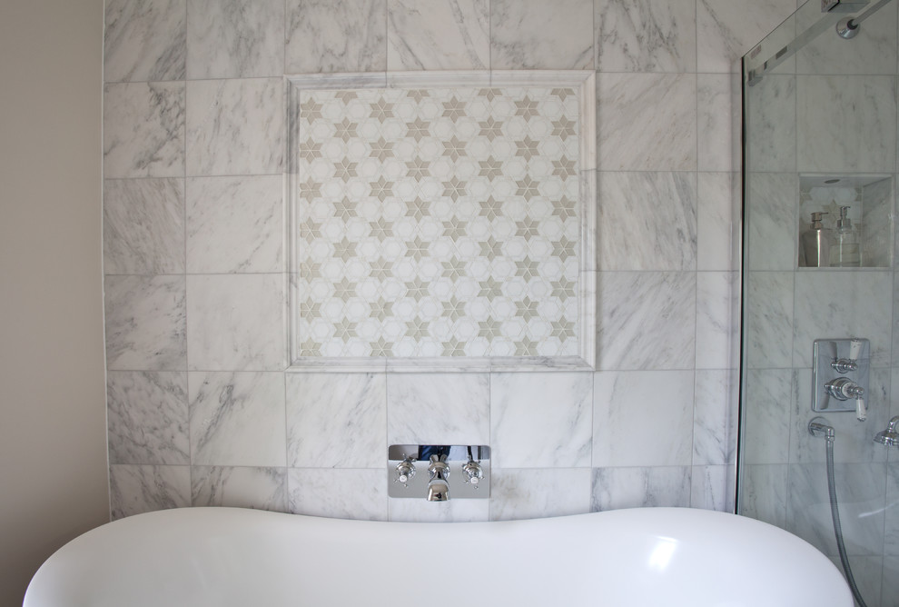 Inspiration for a mid-sized contemporary kids bathroom in Sussex with recessed-panel cabinets, white cabinets, a freestanding tub, a corner shower, a two-piece toilet, white tile, stone slab, white walls and marble floors.
