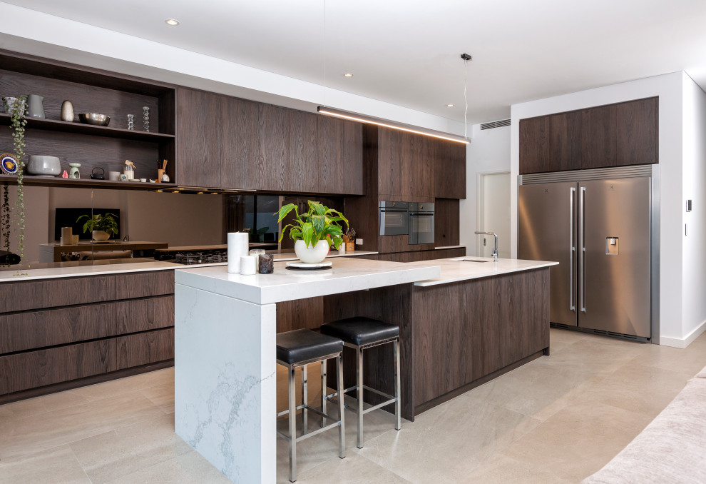 This is an example of a contemporary galley kitchen in Perth with an undermount sink, flat-panel cabinets, dark wood cabinets, stainless steel appliances, with island, beige floor, white benchtop, quartz benchtops and ceramic floors.