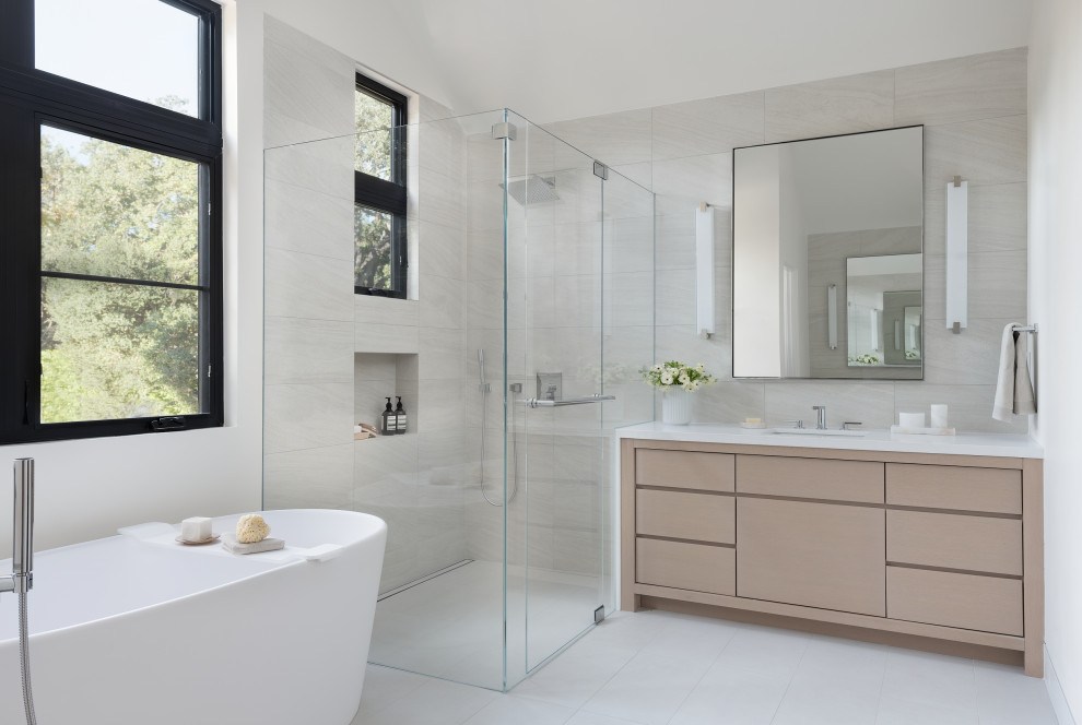 Trendy gray tile gray floor and single-sink bathroom photo in San Francisco with flat-panel cabinets, light wood cabinets, an undermount sink, a hinged shower door, white countertops, a built-in vanity and a niche