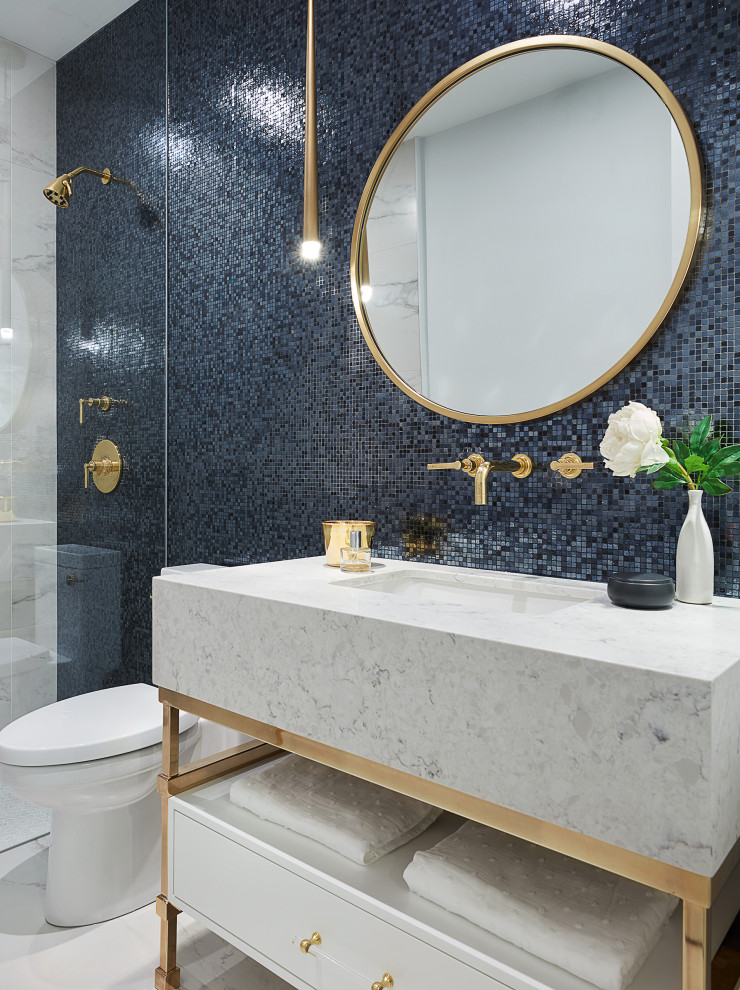 Design ideas for a mid-sized 3/4 bathroom in Toronto with flat-panel cabinets, white cabinets, a curbless shower, a one-piece toilet, blue tile, white walls, marble floors, an undermount sink, engineered quartz benchtops, white floor, white benchtops, a single vanity and a freestanding vanity.