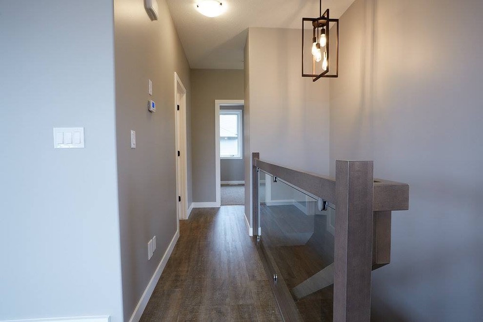 Inspiration for a mid-sized transitional dark wood floor and brown floor hallway remodel with gray walls