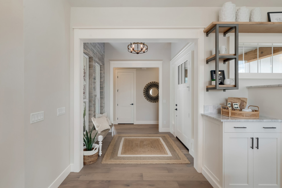 Inspiration for a mid-sized country front door in Boise with grey walls, light hardwood floors, a single front door, a white front door and beige floor.