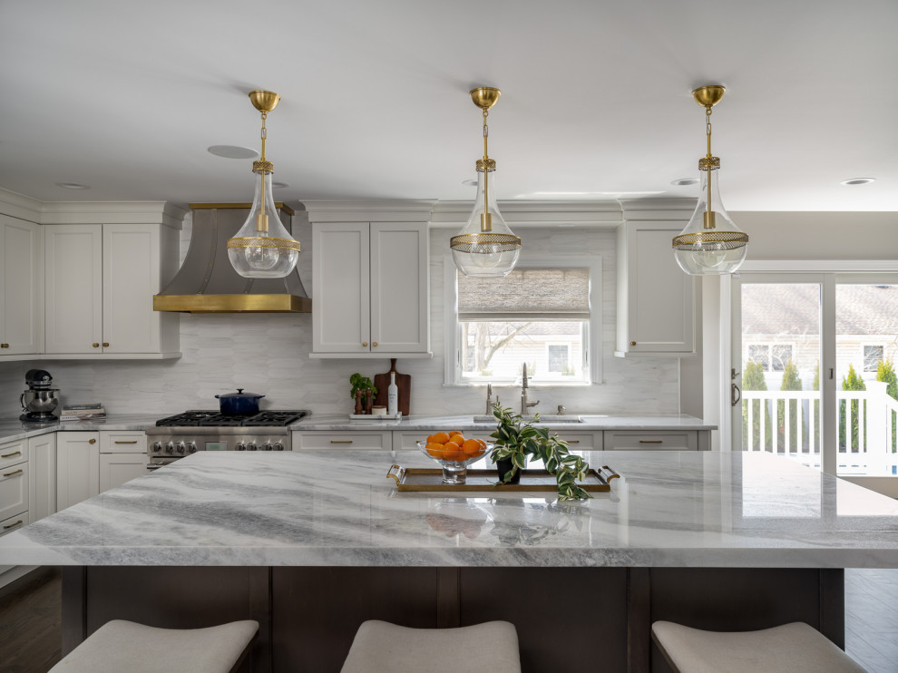 Inspiration for a large transitional l-shaped eat-in kitchen in New York with an undermount sink, recessed-panel cabinets, white cabinets, quartzite benchtops, grey splashback, porcelain splashback, stainless steel appliances, dark hardwood floors, with island, brown floor and white benchtop.
