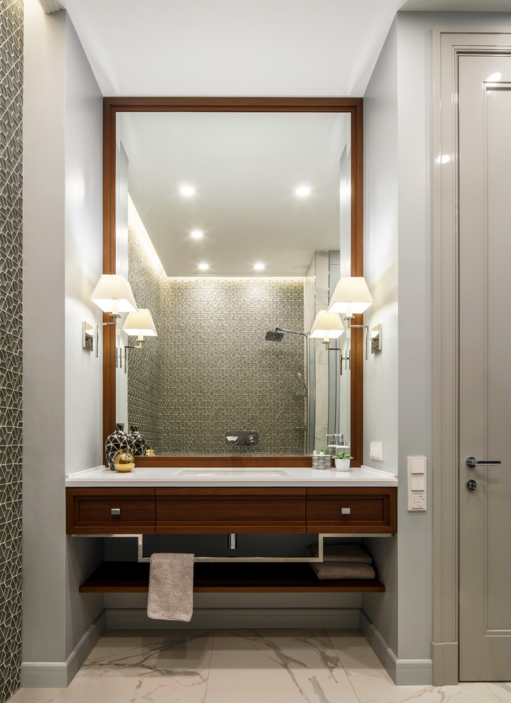 This is an example of a transitional master bathroom in Moscow with recessed-panel cabinets, medium wood cabinets, a shower/bathtub combo, grey walls, an integrated sink, mosaic tile, marble floors and white floor.