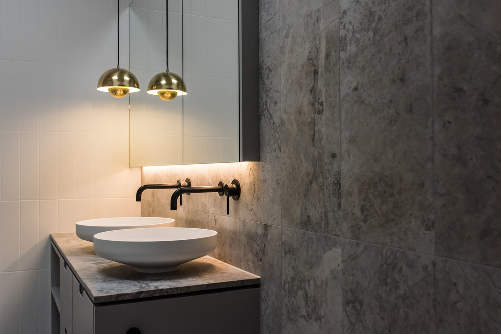 Mid-sized contemporary master bathroom in Melbourne with furniture-like cabinets, grey cabinets, a freestanding tub, an open shower, a one-piece toilet, white tile, marble, grey walls, marble floors, a vessel sink, marble benchtops, grey floor and a hinged shower door.