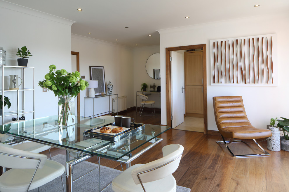 Esempio di una grande sala da pranzo aperta verso il soggiorno minimalista con pareti bianche, parquet scuro e pavimento marrone