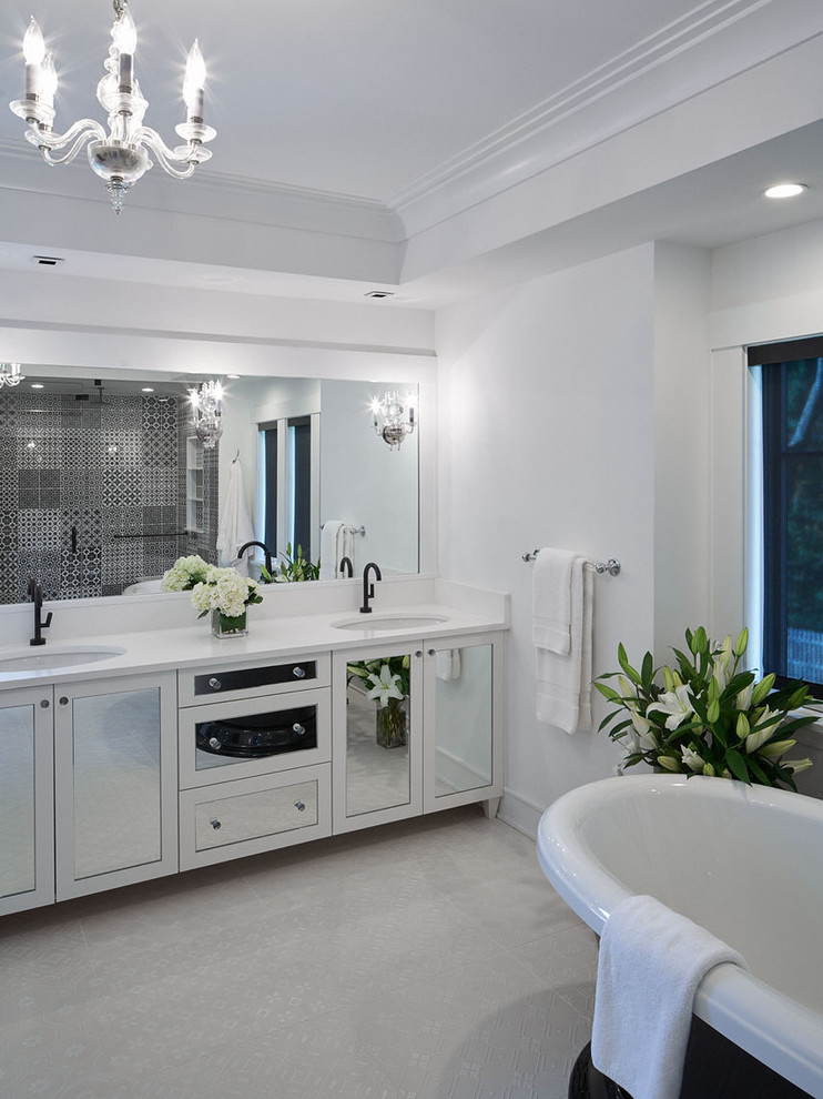 Photo of a large transitional master bathroom in Other with raised-panel cabinets, white cabinets, a freestanding tub, an open shower, a one-piece toilet, white tile, porcelain tile, white walls, porcelain floors, an undermount sink and engineered quartz benchtops.