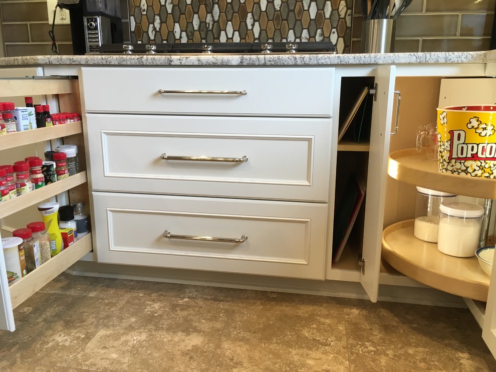 Large transitional l-shaped vinyl floor and beige floor eat-in kitchen photo with a double-bowl sink, recessed-panel cabinets, white cabinets, granite countertops, brown backsplash, ceramic backsplash, stainless steel appliances and an island