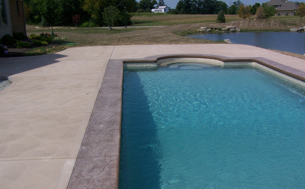 Inspiration for a mid-sized backyard concrete and custom-shaped natural pool remodel in Cincinnati