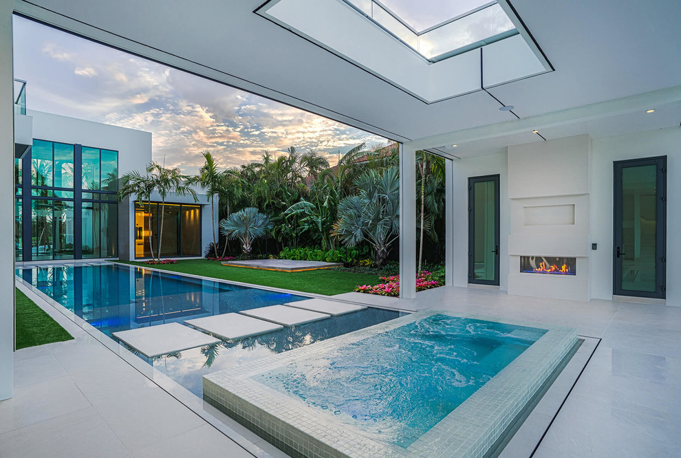 Beach style courtyard rectangular pool in Miami with a hot tub.