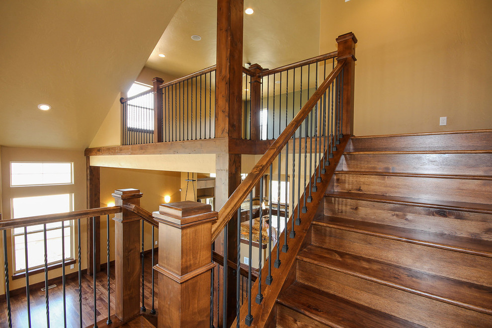 Arts and crafts wood u-shaped staircase in Denver with wood risers.