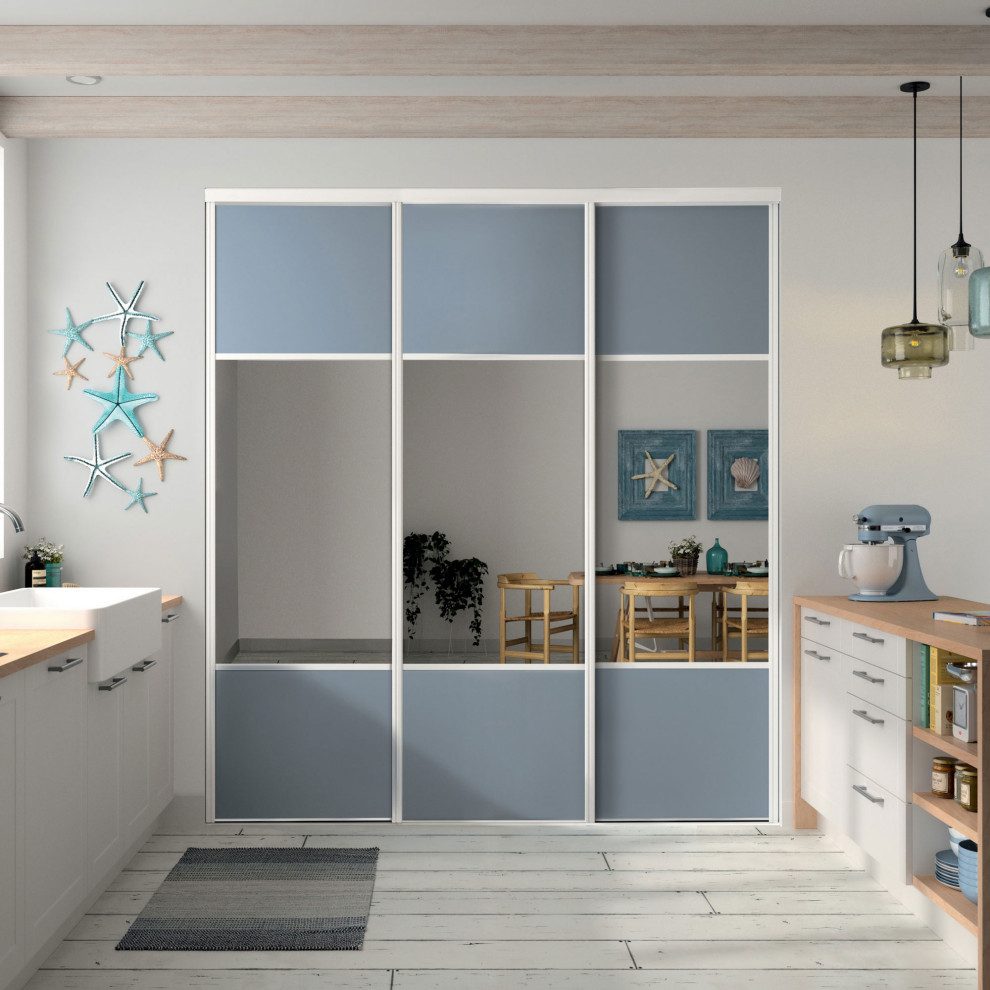 This is an example of a large beach style gender-neutral built-in wardrobe in Other with recessed-panel cabinets and blue cabinets.