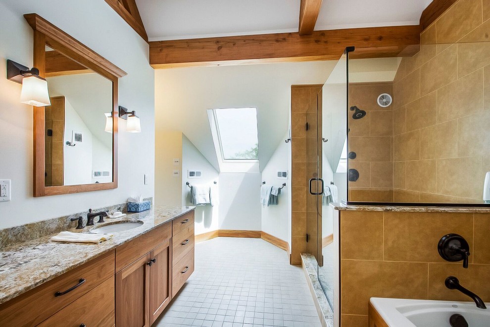 Large traditional master bathroom in Burlington with recessed-panel cabinets, medium wood cabinets, a drop-in tub, an alcove shower, a one-piece toilet, beige tile, ceramic tile, white walls, ceramic floors, an undermount sink and granite benchtops.