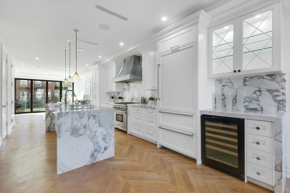 Expansive contemporary single-wall eat-in kitchen in New York with an undermount sink, beaded inset cabinets, white cabinets, marble benchtops, grey splashback, marble splashback, panelled appliances, with island and grey benchtop.
