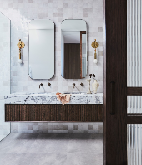 Natural Luxury: Floating Wood Bathroom Vanity with White Marble Tops and Square Tile Backsplash