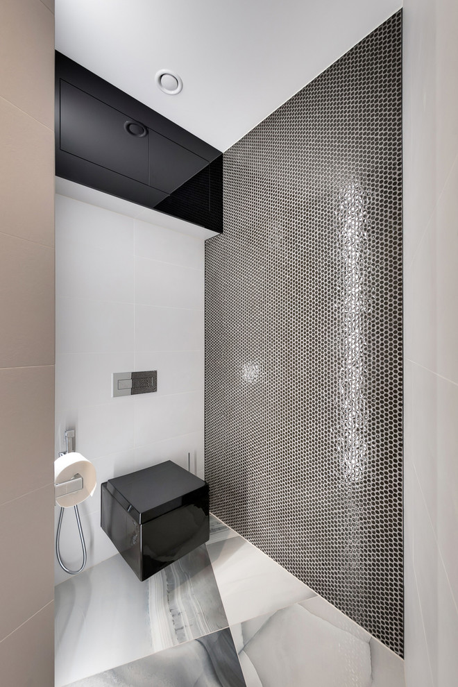 Design ideas for a mid-sized contemporary powder room in Saint Petersburg with a wall-mount toilet, white tile, black tile, mosaic tile and grey floor.