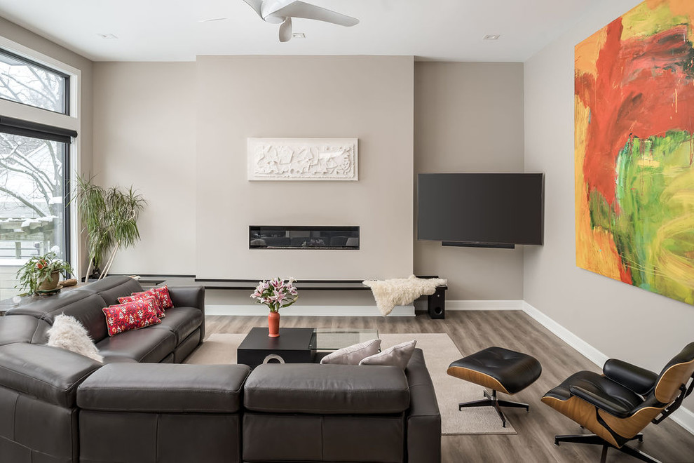 Mid-sized trendy formal and open concept medium tone wood floor and brown floor living room photo in Columbus with a ribbon fireplace, a wall-mounted tv and beige walls