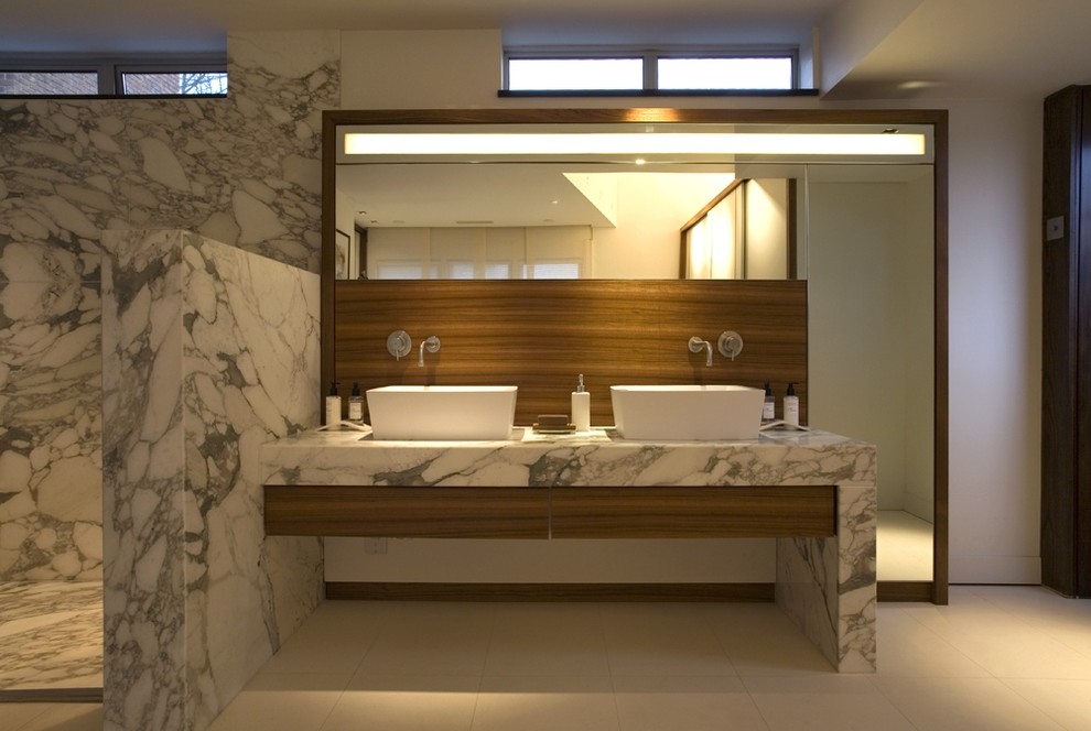 Design ideas for a contemporary bathroom in London with marble benchtops and marble.