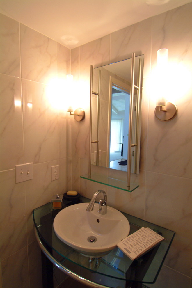 This is an example of a small contemporary powder room in Indianapolis with a vessel sink, glass benchtops, white tile, stone tile, white walls and medium hardwood floors.