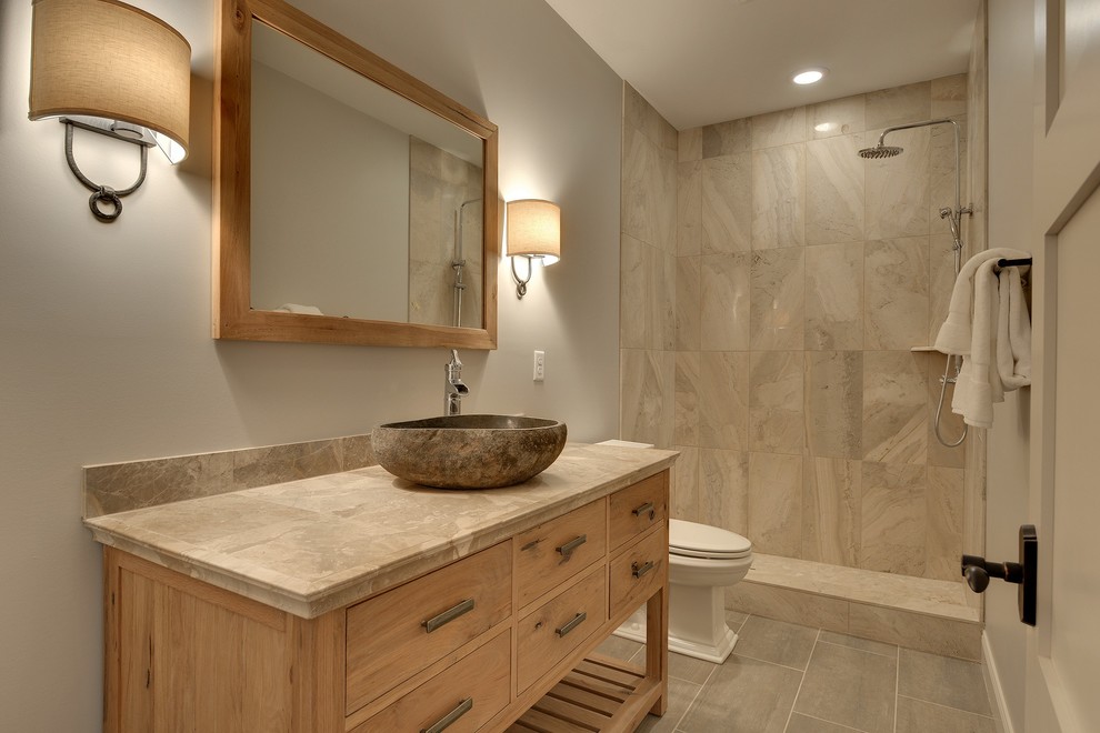 Mid-sized transitional 3/4 bathroom in Minneapolis with a vessel sink, light wood cabinets, tile benchtops, an open shower, a two-piece toilet, gray tile, stone tile, grey walls, ceramic floors, an open shower and flat-panel cabinets.
