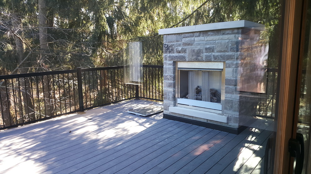 Mid-sized transitional backyard deck photo in Toronto with a fireplace and no cover