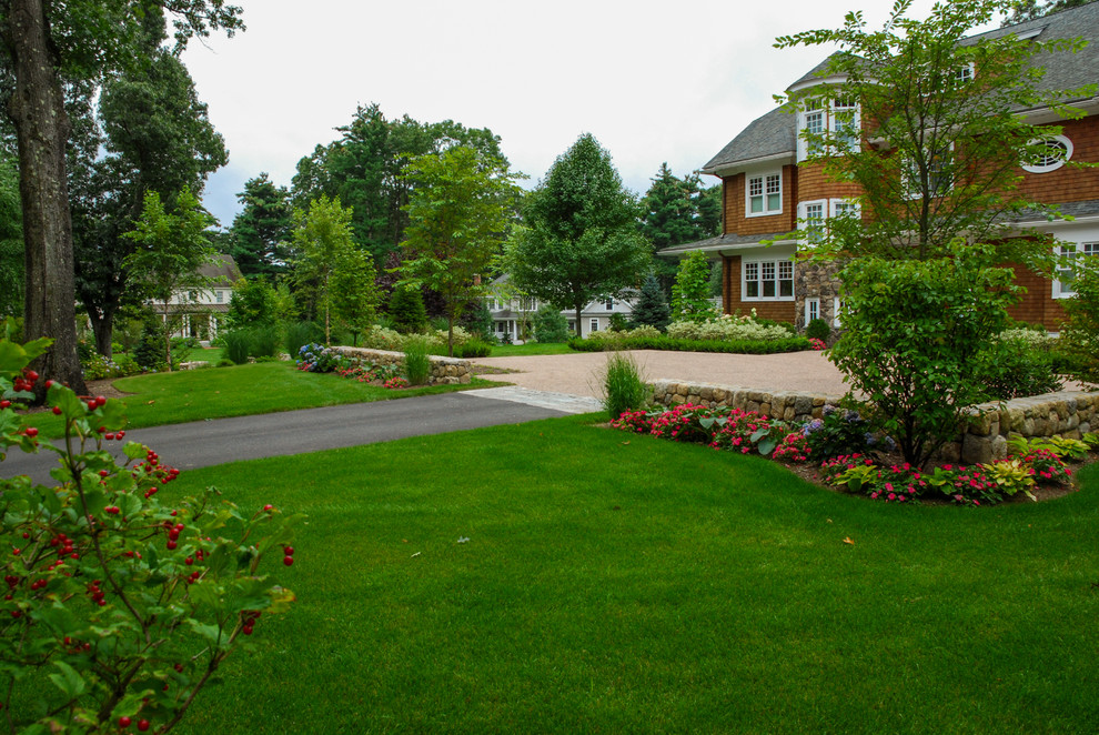 This is an example of a large traditional courtyard full sun driveway in Boston with gravel.