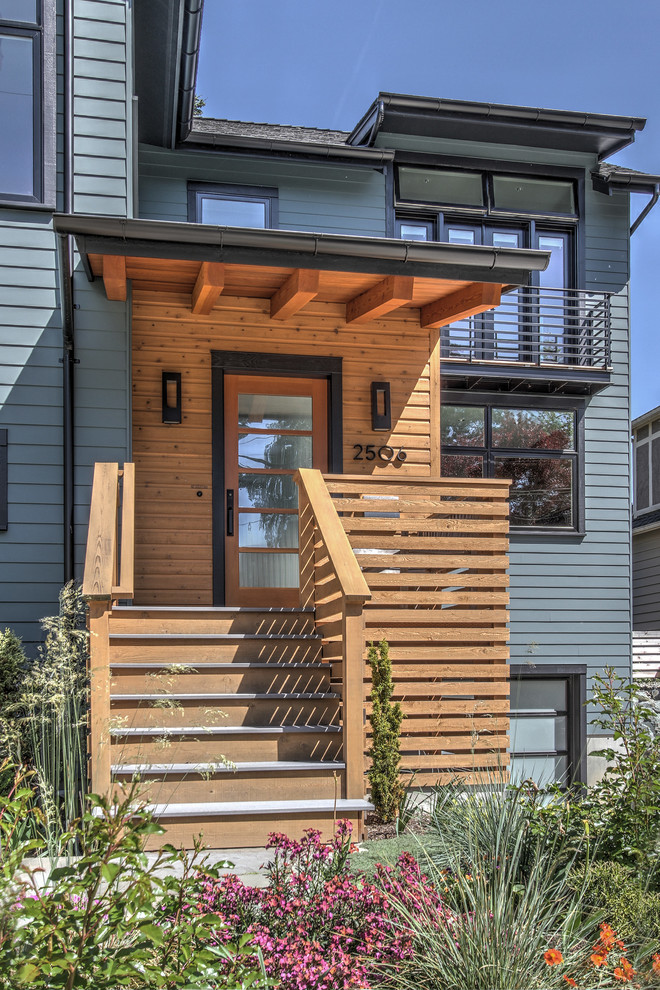 Inspiration for a contemporary entryway remodel in Seattle with a glass front door