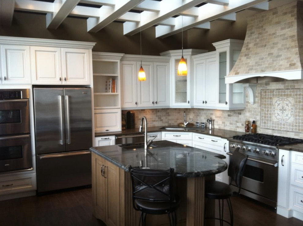 Mid-sized transitional l-shaped dark wood floor and brown floor eat-in kitchen photo in Vancouver with an undermount sink, raised-panel cabinets, white cabinets, granite countertops, multicolored backsplash, stone tile backsplash, stainless steel appliances and an island