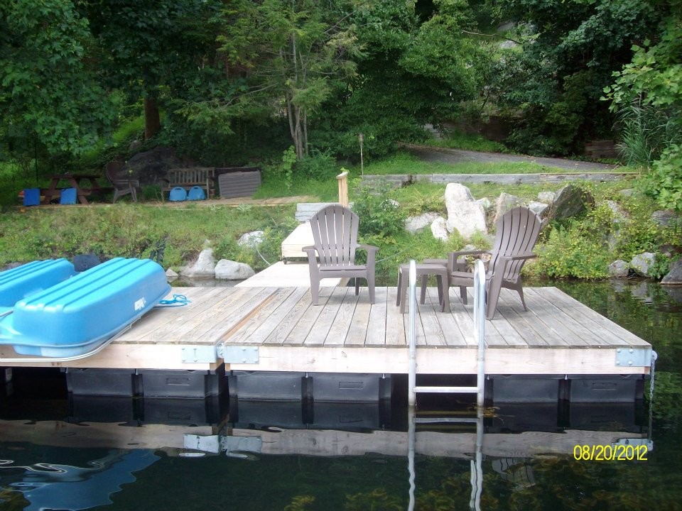 Photo of a country backyard deck in New York with with dock.