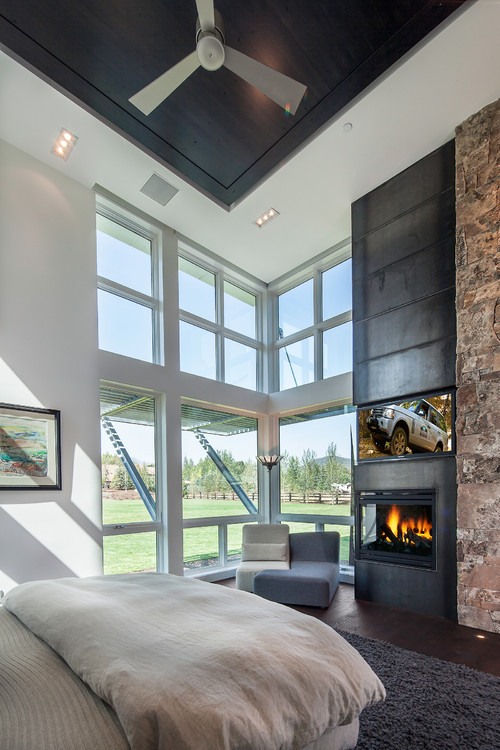 master bedroom with steel & stone fireplace