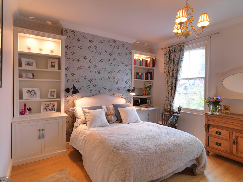 Mid-sized traditional kids' room in London with multi-coloured walls and medium hardwood floors for girls.