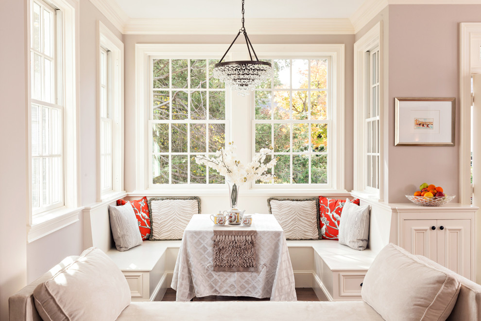 This is an example of a traditional open plan dining in Boston with beige walls.