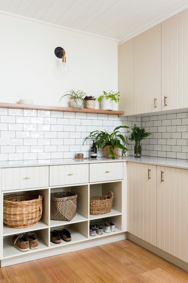 This is an example of a transitional mudroom in Melbourne with white walls and light hardwood floors.