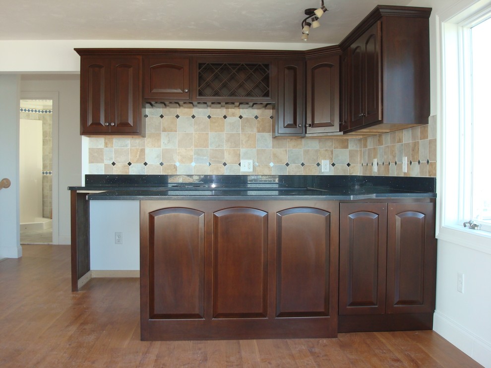 Inspiration for a transitional medium tone wood floor kitchen remodel in Providence with raised-panel cabinets, dark wood cabinets, no island and an undermount sink