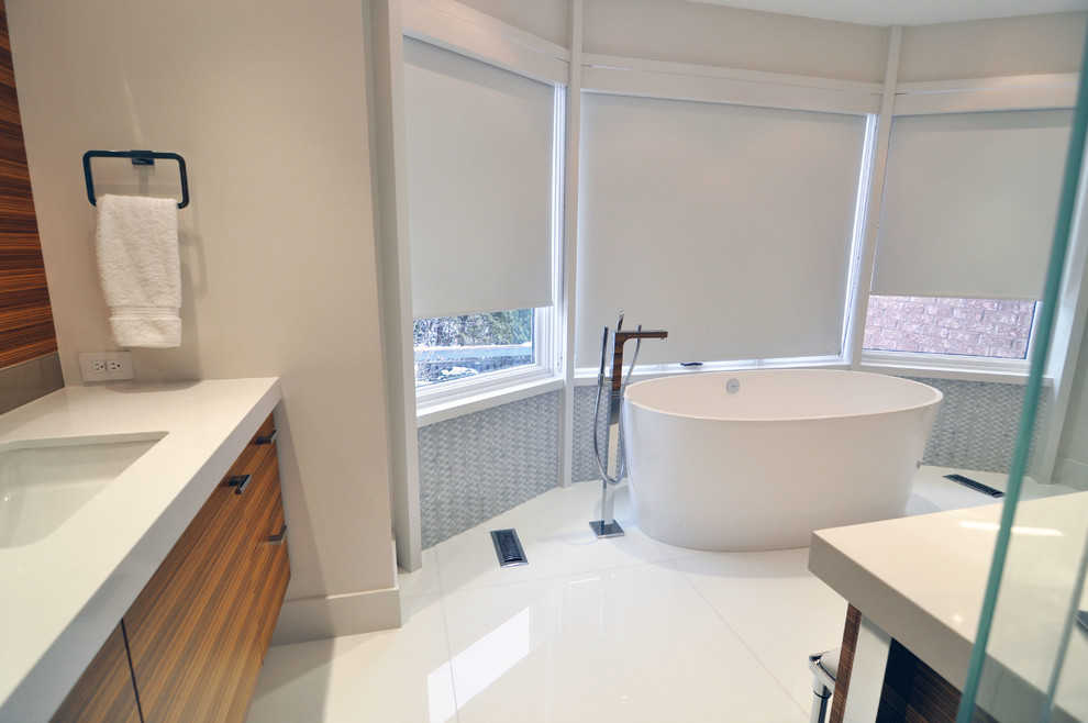 Design ideas for a large modern master bathroom in Toronto with a drop-in sink, engineered quartz benchtops, a freestanding tub, an alcove shower, a one-piece toilet, blue tile, glass tile, white walls, ceramic floors, white floor and a hinged shower door.
