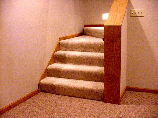 This is an example of a small traditional carpeted curved staircase in Indianapolis with carpet risers.