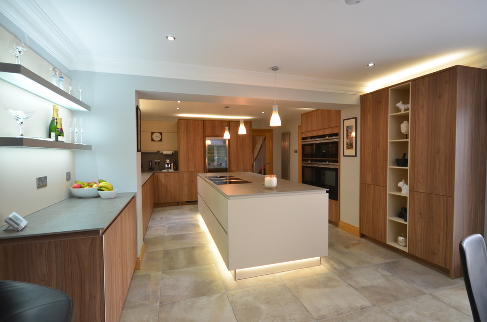 Mid-sized contemporary u-shaped eat-in kitchen in Other with an integrated sink, panelled appliances, with island, beaded inset cabinets, medium wood cabinets, wood benchtops, brown splashback, marble splashback, ceramic floors and grey floor.