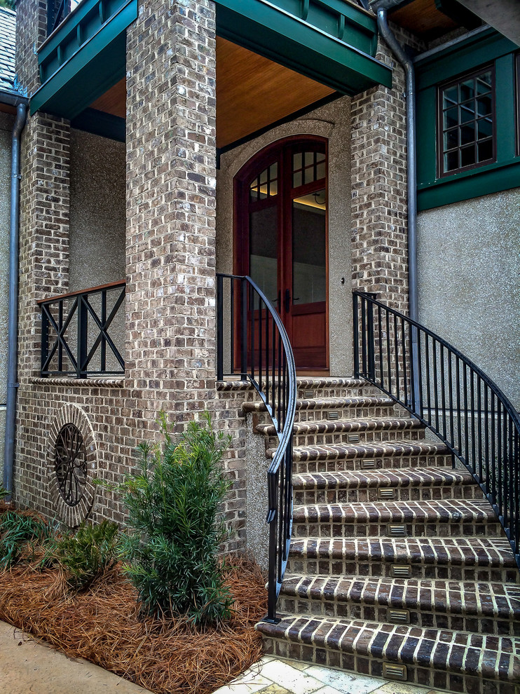 This is an example of a large traditional front door in Charleston with brick floors, a double front door, grey walls and a medium wood front door.